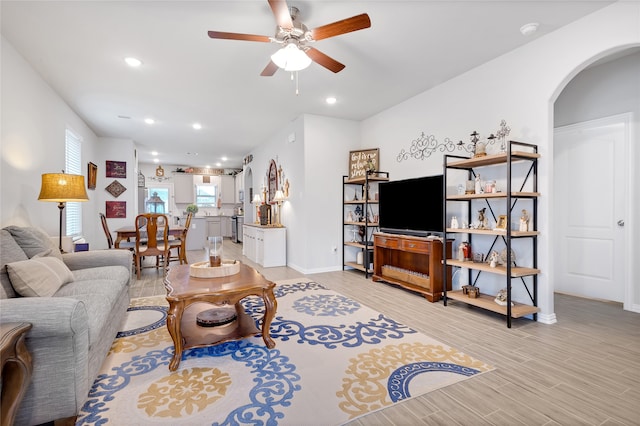 living room featuring ceiling fan and light hardwood / wood-style flooring