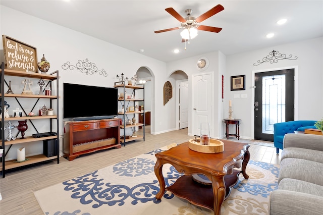 living room with ceiling fan and light hardwood / wood-style floors