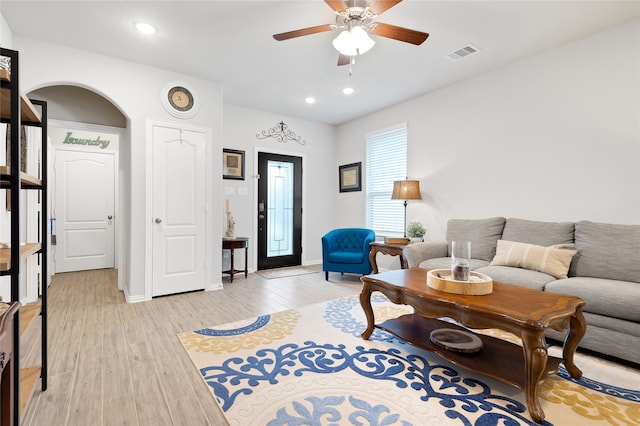 living room featuring ceiling fan and light hardwood / wood-style flooring