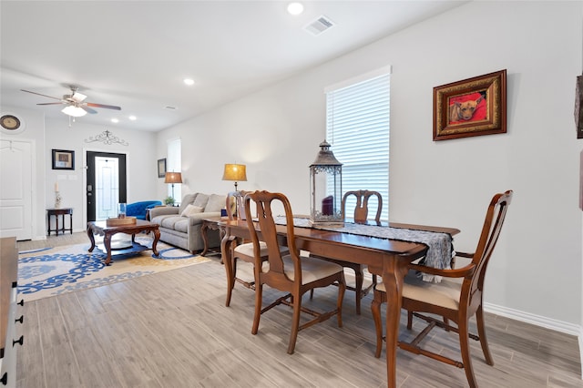 dining room featuring ceiling fan, hardwood / wood-style floors, and a healthy amount of sunlight