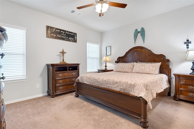 bedroom featuring ceiling fan and light colored carpet