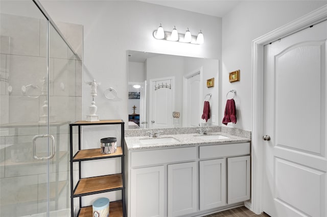 bathroom featuring vanity and an enclosed shower