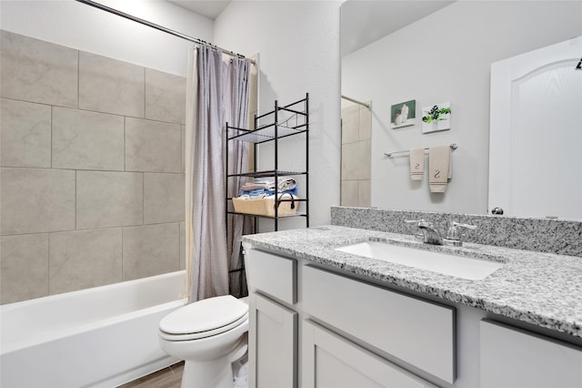 full bathroom with hardwood / wood-style flooring, shower / tub combo with curtain, vanity, and toilet