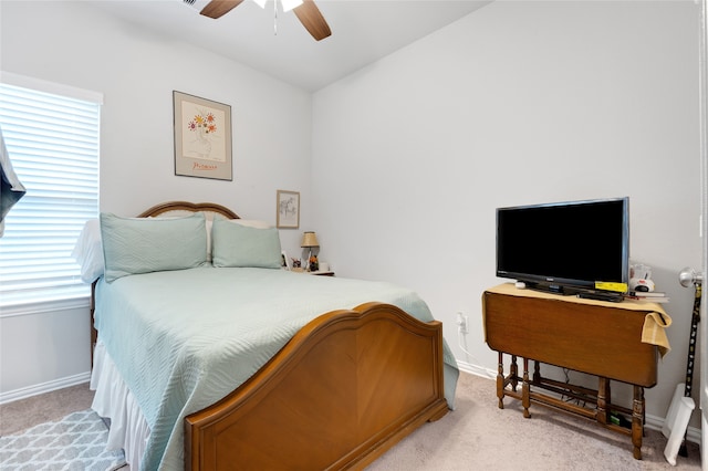 bedroom with ceiling fan and light colored carpet