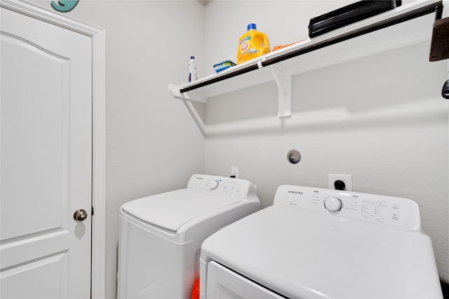 clothes washing area featuring independent washer and dryer