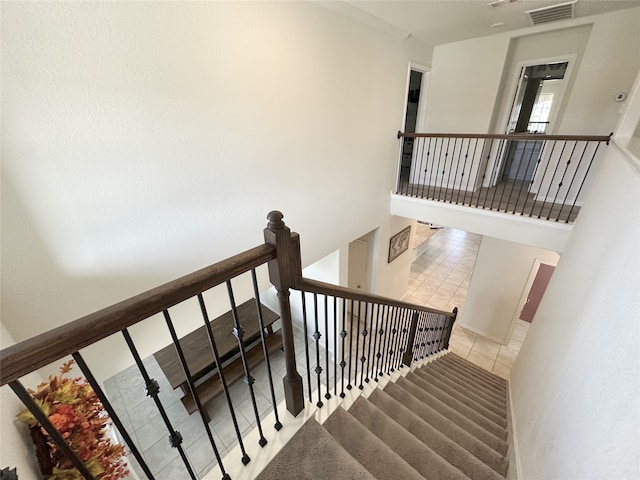 stairway featuring tile patterned floors