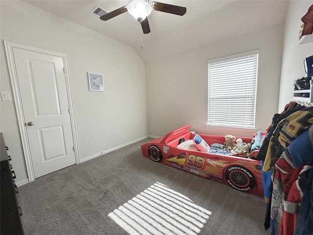 bedroom with ceiling fan, dark carpet, and vaulted ceiling