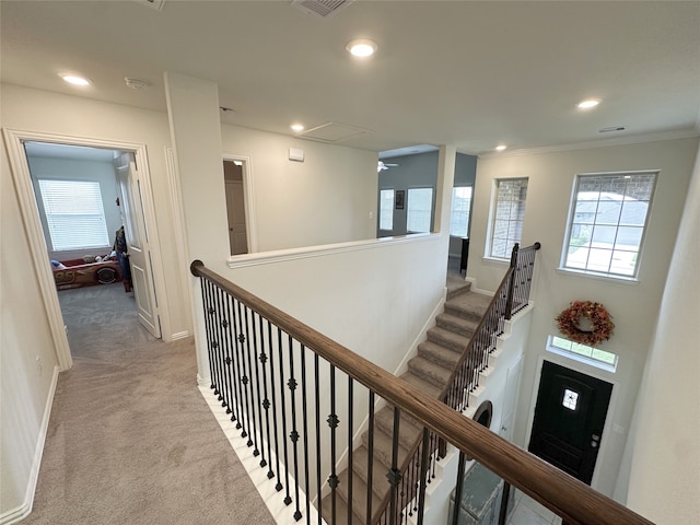 corridor with light colored carpet and ornamental molding