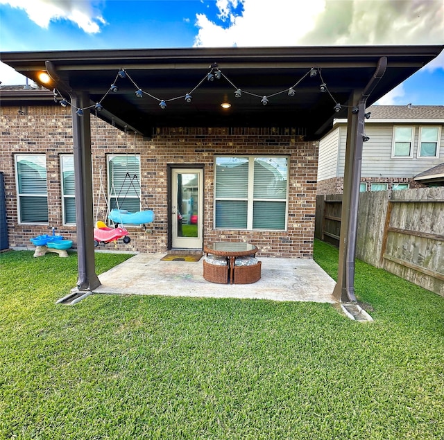 rear view of house with a patio area and a lawn