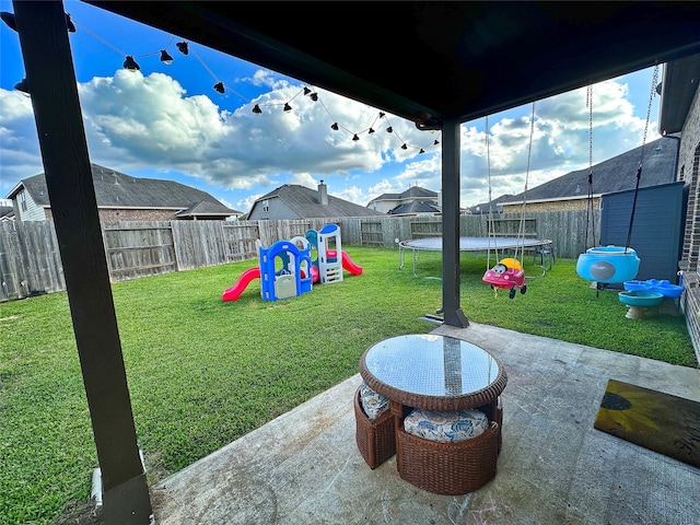 view of yard with a playground, a patio area, and a trampoline