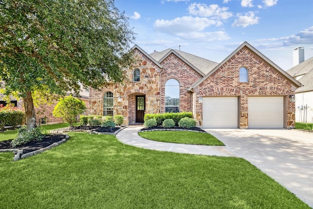 view of front of property with a front yard and a garage