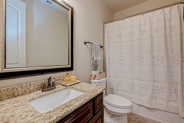 full bathroom with vanity, tile patterned floors, toilet, and shower / tub combo with curtain