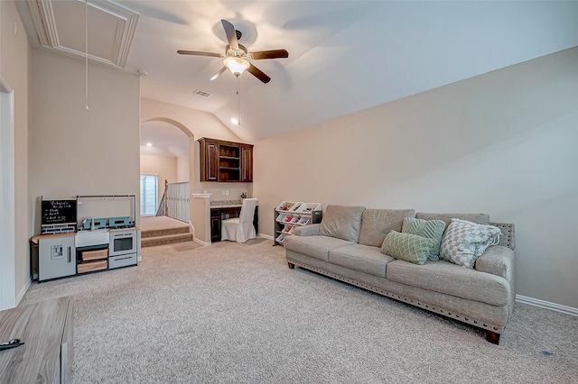 carpeted living room with lofted ceiling and ceiling fan