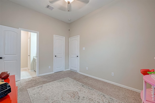 bedroom featuring light carpet and ensuite bath