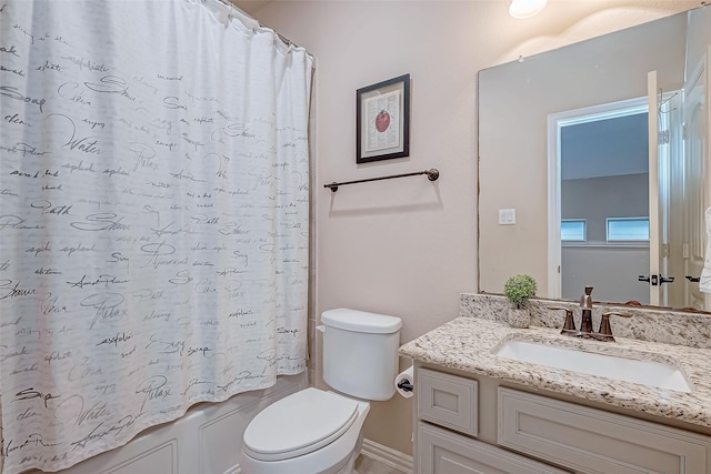 full bathroom featuring vanity, shower / bath combination with curtain, and toilet