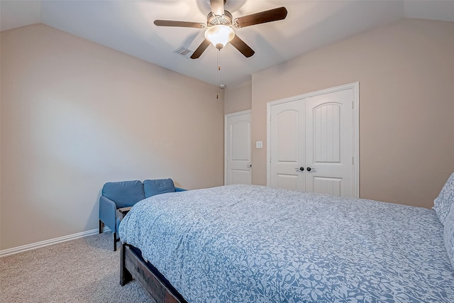 bedroom featuring lofted ceiling, carpet flooring, ceiling fan, and a closet