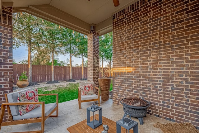 view of patio featuring ceiling fan and an outdoor fire pit