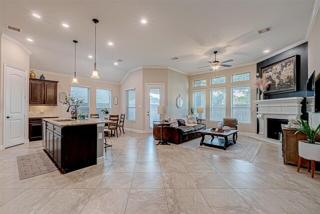 tiled living room with sink, ornamental molding, a healthy amount of sunlight, and ceiling fan