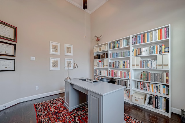 home office featuring dark wood-type flooring and crown molding