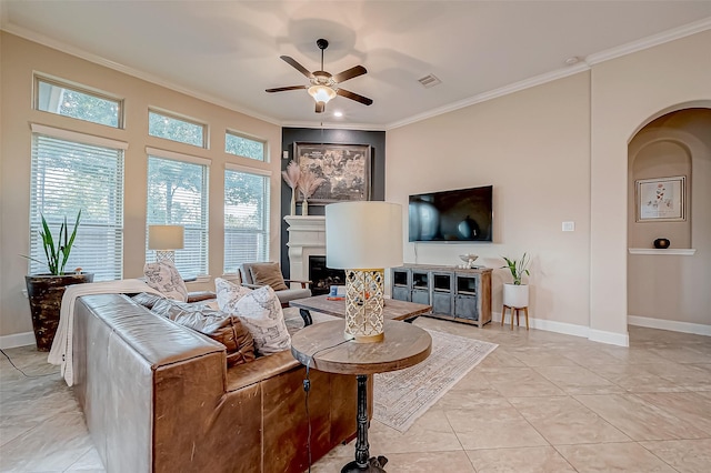 living room with ornamental molding, light tile patterned floors, and ceiling fan