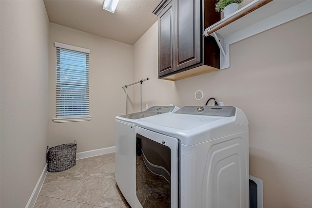 laundry room featuring independent washer and dryer and cabinets