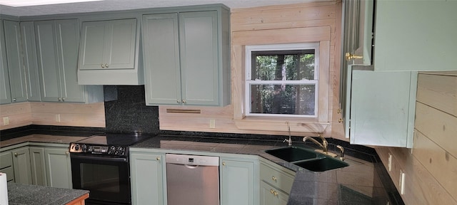 kitchen featuring backsplash, stainless steel dishwasher, gray cabinetry, black range with electric cooktop, and sink