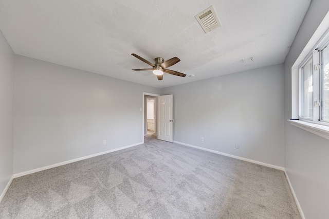 unfurnished room with ceiling fan and light colored carpet