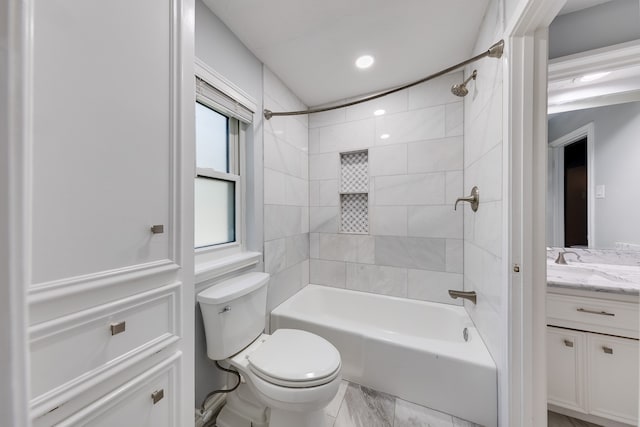 full bathroom with vanity, toilet, and tiled shower / bath