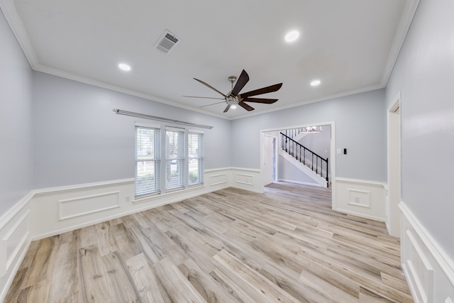 unfurnished room with ceiling fan, light wood-type flooring, and crown molding