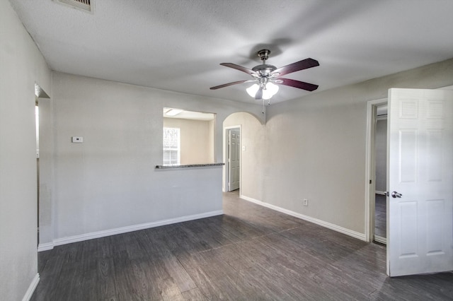 spare room with ceiling fan, dark hardwood / wood-style flooring, and a textured ceiling