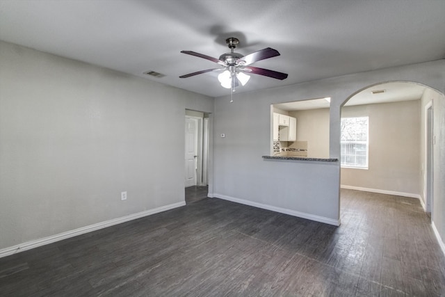 unfurnished living room with ceiling fan and dark hardwood / wood-style flooring