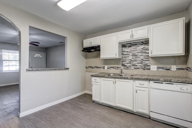 kitchen with backsplash, light wood-type flooring, white dishwasher, sink, and white cabinetry