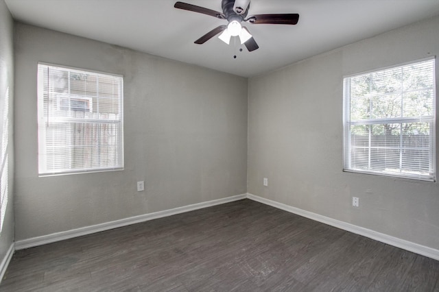 empty room featuring ceiling fan and dark hardwood / wood-style flooring