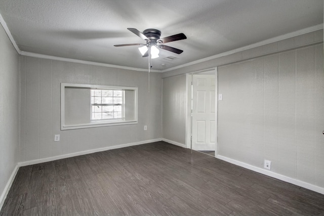 spare room featuring a textured ceiling, crown molding, ceiling fan, and dark wood-type flooring