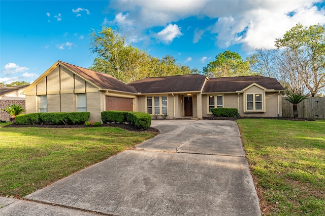 ranch-style house featuring a garage and a front lawn