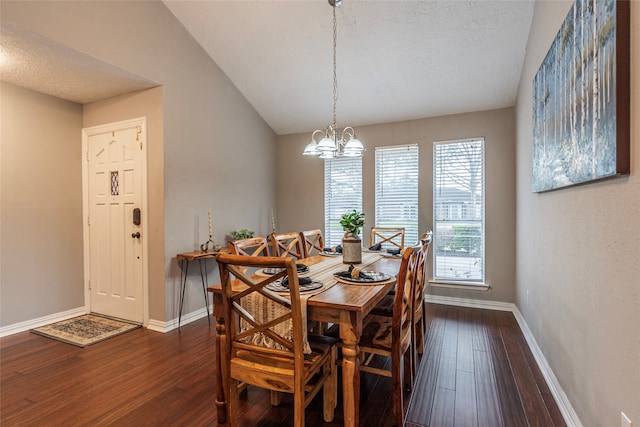 dining space with a textured ceiling, dark hardwood / wood-style flooring, vaulted ceiling, and a notable chandelier