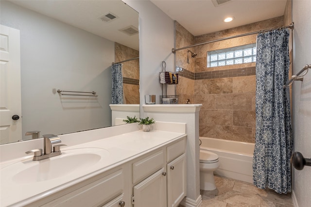 full bathroom featuring shower / bath combo, vanity, and toilet