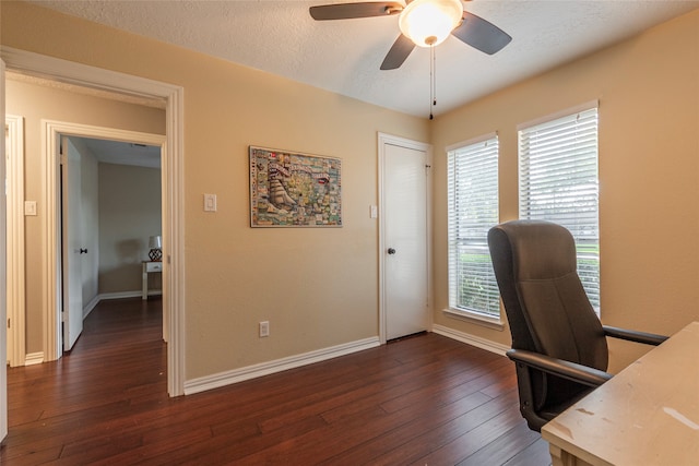 office space featuring dark hardwood / wood-style floors, ceiling fan, a textured ceiling, and a wealth of natural light