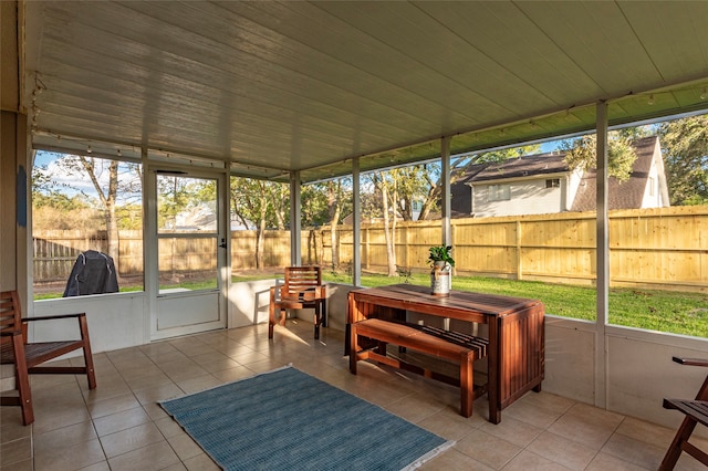 sunroom featuring a healthy amount of sunlight and wood ceiling