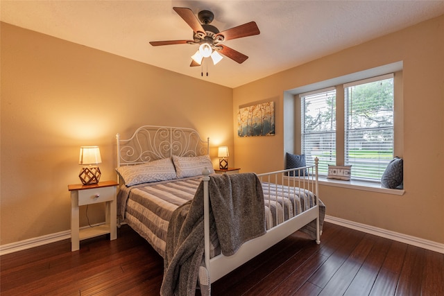 bedroom featuring ceiling fan and dark wood-type flooring