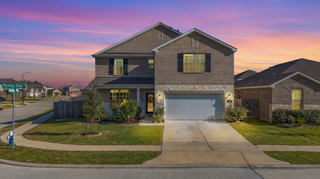 view of front property with a yard and a garage