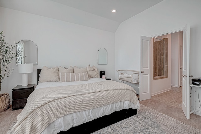 carpeted bedroom with lofted ceiling