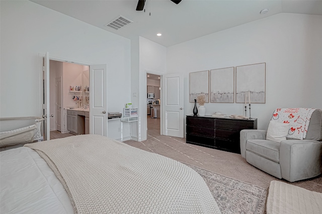 bedroom with light carpet, high vaulted ceiling, ensuite bath, and ceiling fan