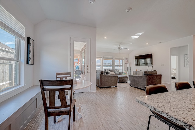 dining room with ceiling fan, light wood-type flooring, and lofted ceiling