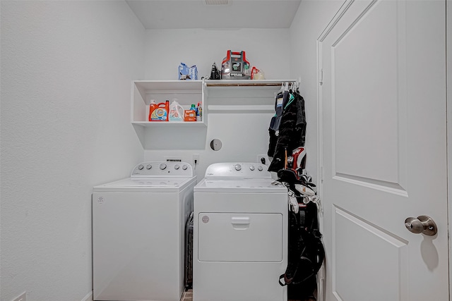 clothes washing area featuring washing machine and clothes dryer