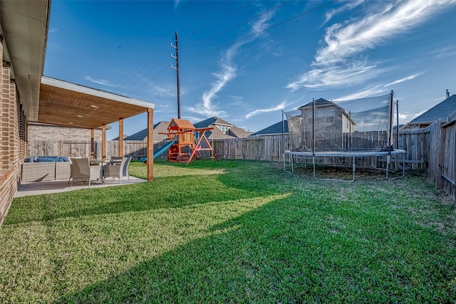 view of yard featuring a playground, a patio area, and a trampoline