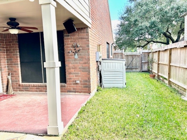 view of yard with a patio and ceiling fan