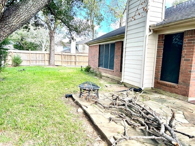 view of yard featuring an outdoor fire pit and a patio