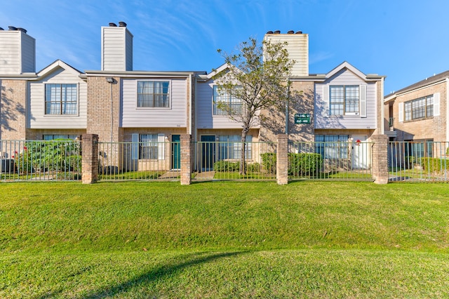 rear view of property featuring a lawn