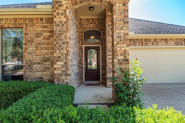 doorway to property with a garage